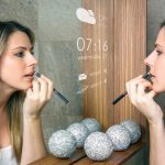 Woman applying makeup and using a smart mirror